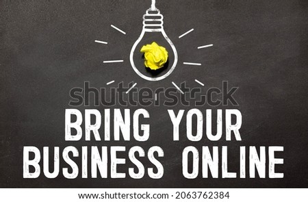 bring your business online. text on white paper on wood background near calculator, paper clips, alarm clock, glasses