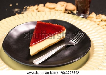 Red fruits Cheesecake on a black plate