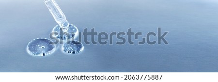 Banner made with transparent gel or serum pipette with drops. Cosmetics concept with fluid. Minimalism style and extreme close up. Royalty-Free Stock Photo #2063775887