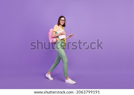Full size profile side photo of young girl go university use smartphone courses academic isolated over purple color background