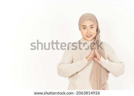 Fingers crossed smiling relaxed and cheerful of Beautiful Asian Woman Wearing Hijab Isolated On White Background