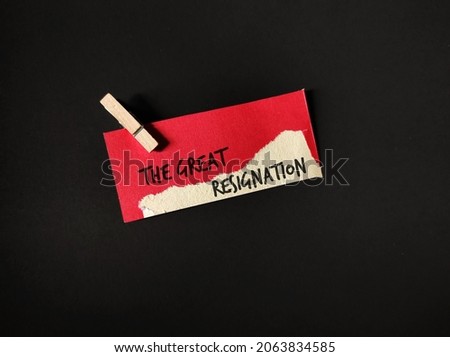 Red torn paper clip cloth pin on black background with text written THE GREAT RESIGNATION, concept of transition to post-pandemic workplace, the big quit trend, millions workers leave full time job