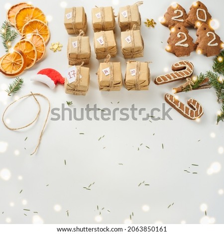 Advent calendar for waiting for Christmas and New Year among dried oranges, gingerbread cookies and fir twigs. Eco-friendly packaging, zero waste. Copyspace