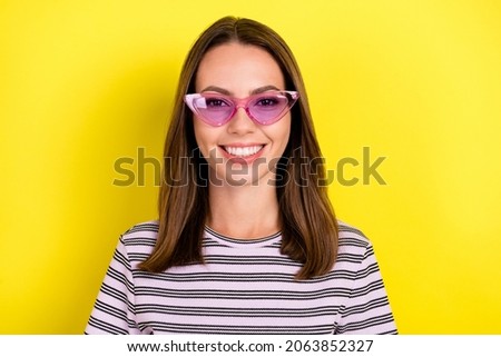 Photo of optimistic millennial brunette lady wear eyewear white t-shirt isolated on yellow background