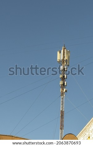 5G mobile phone telecommunication tower station, clear blue sky background