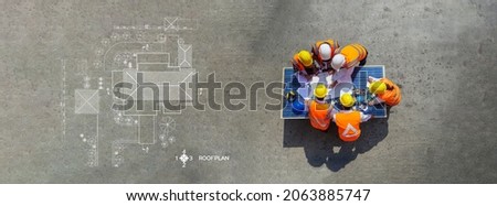 Top view of architectural engineer working on his blueprints with documents on construction site. meeting, discussing,designing, planing, roof plan Royalty-Free Stock Photo #2063885747