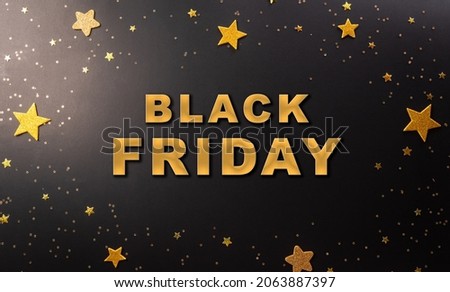 Top view of Black Friday sales discount concept in round frame of golden stars with the text on dark background.