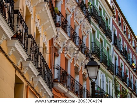 Exterior view of beautiful historical buildings in Madrid, Spain, Europe. Colorful Mediterranean street scene in the former Jewish quarter, Lavapiés, Embajadores neighborhood of the Spanish capital. Royalty-Free Stock Photo #2063904194