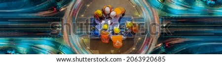 Top view of architectural engineer working on solar panel and his blueprints with Solar photovoltaic equipment on construction site. meeting, Road traffic an important infrastructure Royalty-Free Stock Photo #2063920685