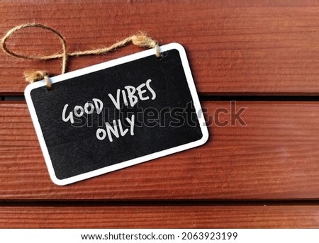 Chalkboard on wood background with text written GOOD VIBES ONLY, self reminder to avoid negative people or thoughts, brings in only positive thoughts and people Royalty-Free Stock Photo #2063923199