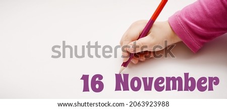 A child's hand writes 16 november in lilac pencil. Banner with copy space