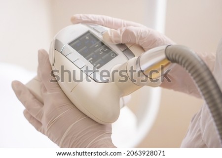 Close up hand holding of vacuum roller massage apparatus . Endermologie is the only non-invasive method designed to reduce the appearance of cellulite. Royalty-Free Stock Photo #2063928071