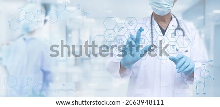 Medical technology, healthcare and medicine, telemedicine, virtual hospital concept. Doctor with stethoscope touching on virtual screen with health technology icons and blurred hospital as background