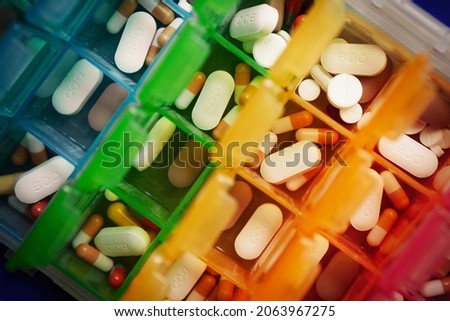 Medication, including anti rejection drugs, after a kidney transplant, stored in a weekly pill box Royalty-Free Stock Photo #2063967275