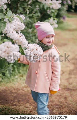 a girl's walk through the lilac park in the spring