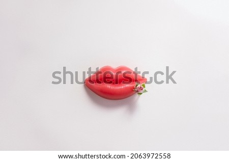 Plasticine lips and blooming flower on pastel background. Minimal creative concept of herpes disease. Copy space