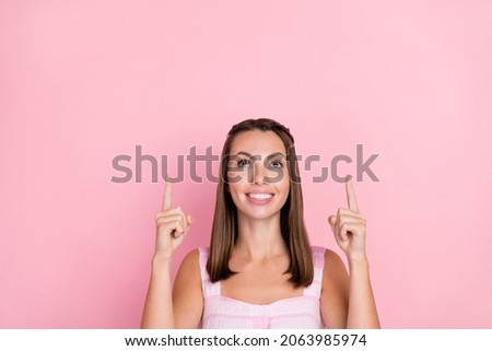 Photo of young lady good mood indicate fingers empty space promo direct advert isolated over pink color background