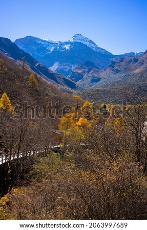 Autumn scenery of Huanglong. Huanglong Scenic Area is located in Songpan County, Sichuan, China. 
The peak in the picture is the main peak of Minshan mountain range-Xuebaoding.