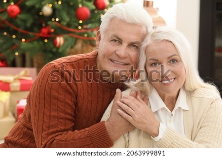 Happy mature couple at home. Christmas celebration