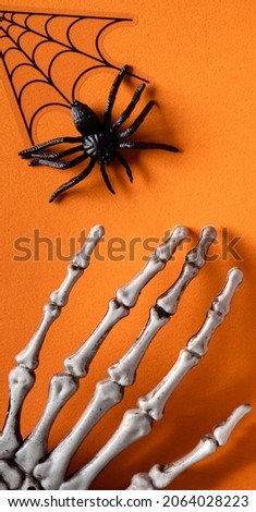 Top view of creative Halloween concept decoration on orange paper table background.
