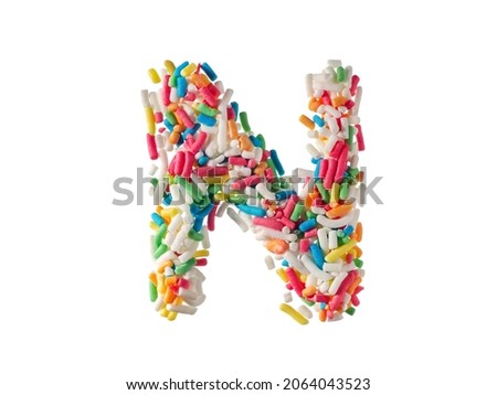 Multi color sugar sprinkles letter N on white background
