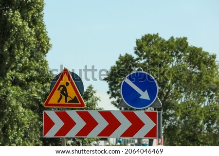 Barricade with traffic signs outdoors. Road repair
