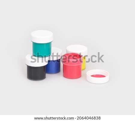Bottles with multicolored gouache isolated on white background