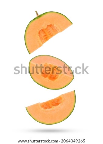 Fresh cantaloupe melon slices falling in the air isolated on white background. Royalty-Free Stock Photo #2064049265