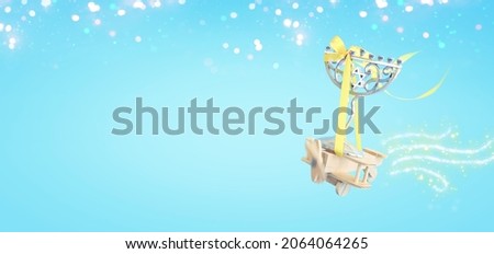 Image of jewish holiday Hanukkah with menorah (traditional candelabra) over wooden toy plane and pastel blue background