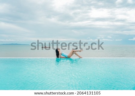 Retreat and vacation. Portrait beautiful young asian woman enjoying around outdoor swimming pool in hotel resort. Attractive girl relax in summer season.