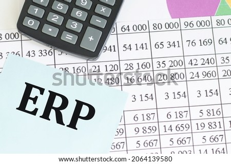 sticker with text ERP on the background with the financial report. It can be used as a business and financial concept