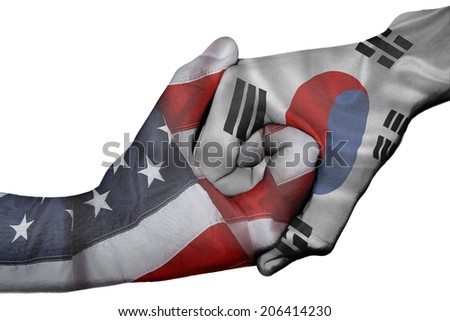 Diplomatic handshake between countries: flags of United States and South Korea overprinted the two hands Royalty-Free Stock Photo #206414230