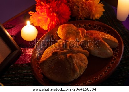 Sweet traditional pan de muerto and cempasuchil flowers in altar background. Day of the dead concept