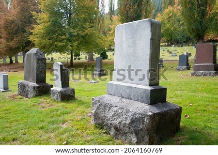 Old blank cemetery tombstones on a fall day. Royalty-Free Stock Photo #2064160769