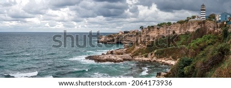 Lighthouse On The Rocks near Sile, Istanbul, Turkey, Black Sea. Lighthouse on rock near sea. Ocean coast with rocks and lighthouse. wide panorama Royalty-Free Stock Photo #2064173936