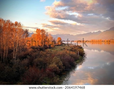 Autum View from The Pitt River Bridge. Golden Ears Mountains, Pitt River and mirror reflection of clouds. Royalty-Free Stock Photo #2064197468