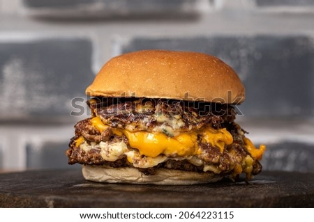 Burger with beef, cheese, and cheese crunch Royalty-Free Stock Photo #2064223115