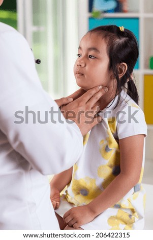 Vertical view of pediatrician examining lymph nodes Royalty-Free Stock Photo #206422315
