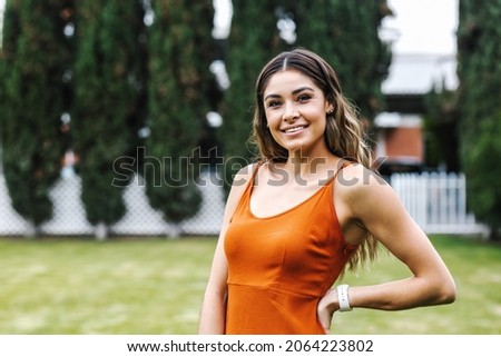 portrait of young Latin woman smiling in park in Mexico Latin America