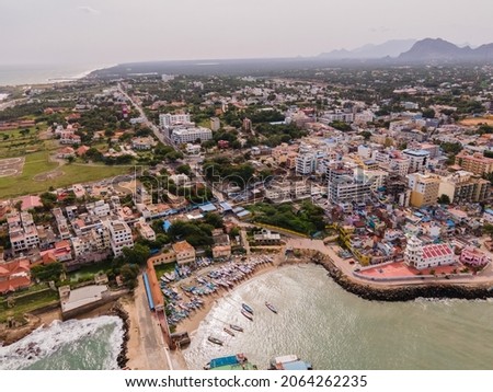 drone shot aerial view top angle photo of kanyakumari seaside Town india southern tip statue seawater waves foam seashore beaches cloudy bright sunny day beautiful scenery natural background 