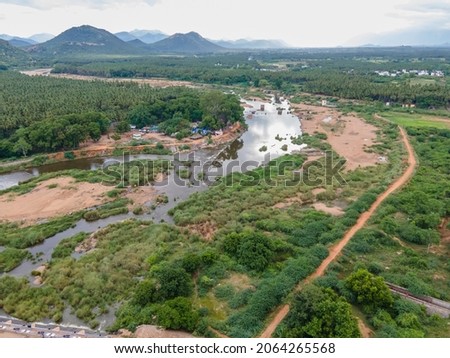 drone shot photo of track road river dam irrigation aerial view top angle bright sunny day beautiful scenery natural rural tourism destination India tamilnadu 