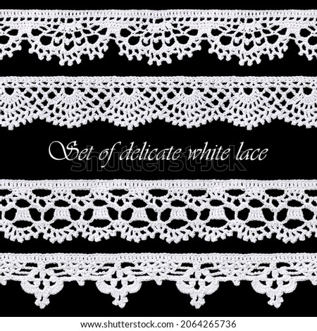 Set of white tape lace on a black background. The lace is crocheted by hand. Vintage style. Material for stylish graphic decoration. Royalty-Free Stock Photo #2064265736
