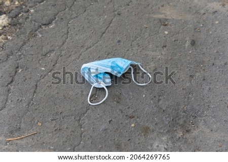 Blue protective mask against infection on the ground
