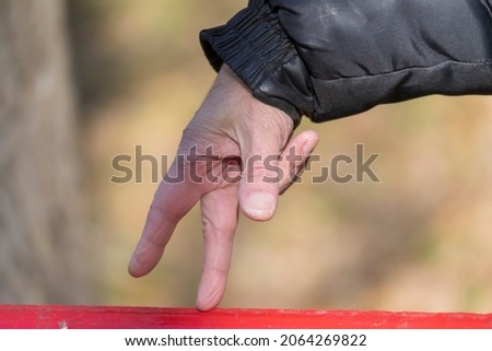 Two fingers walk on a bench, imitation of walking fingers