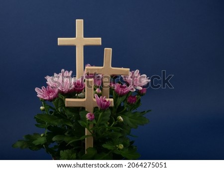 Composition of flowers and wooden cross for all souls day. Also suitable for funeral, mourning, grief.