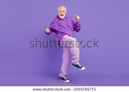 Full length body size view of attractive cheerful grey-haired man dancing clubbing isolated over bright violet purple color background