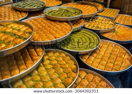 Baklava varieties on dessert store. Turkish baklava on tray. Traditional Baklava from Gaziantep, Turkey. Baklava with pistachio. Royalty-Free Stock Photo #2064302351