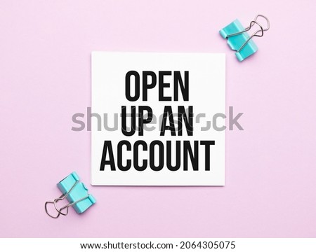 white paper with text OPEN UP AN ACCOUNT on a yellow background with stationery