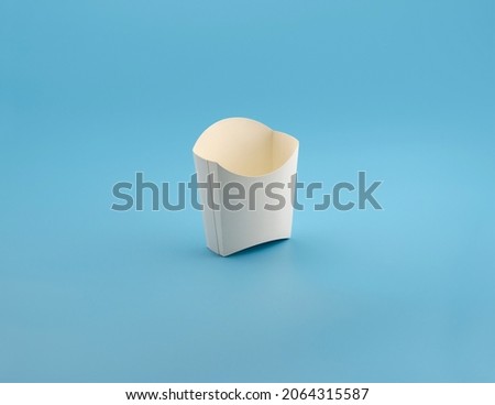 small cardboard box for fries empty on blue background Royalty-Free Stock Photo #2064315587