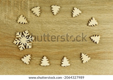 Wooden background for a Christmas banner. Snowflake, Christmas trees. copy space. Wooden figures.